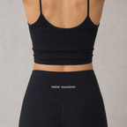 Close-up of the high waistband and small Saint Maxime logo on black bamboo leggings